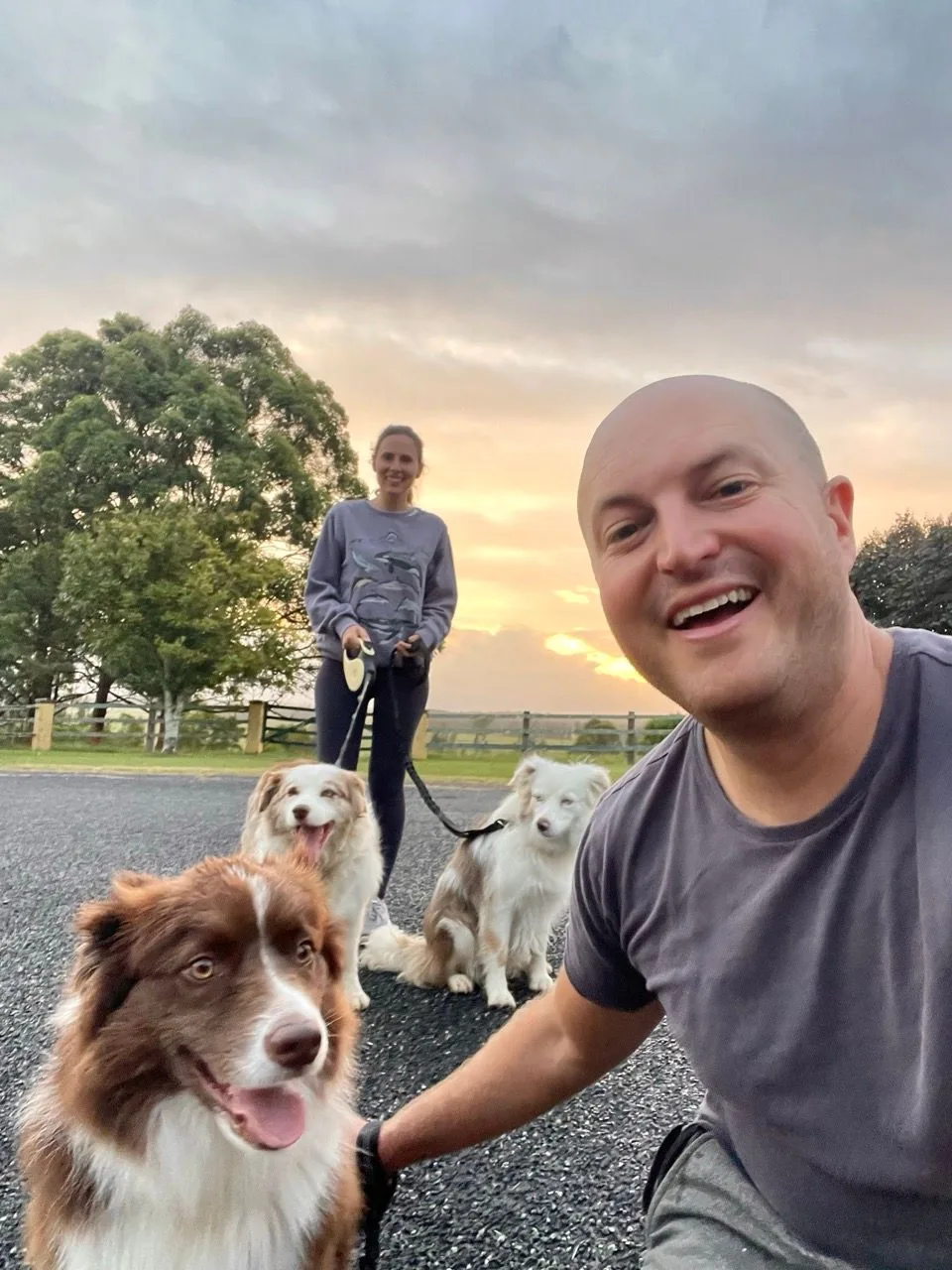 Kyle and Kelly with their dogs outside in the evening light